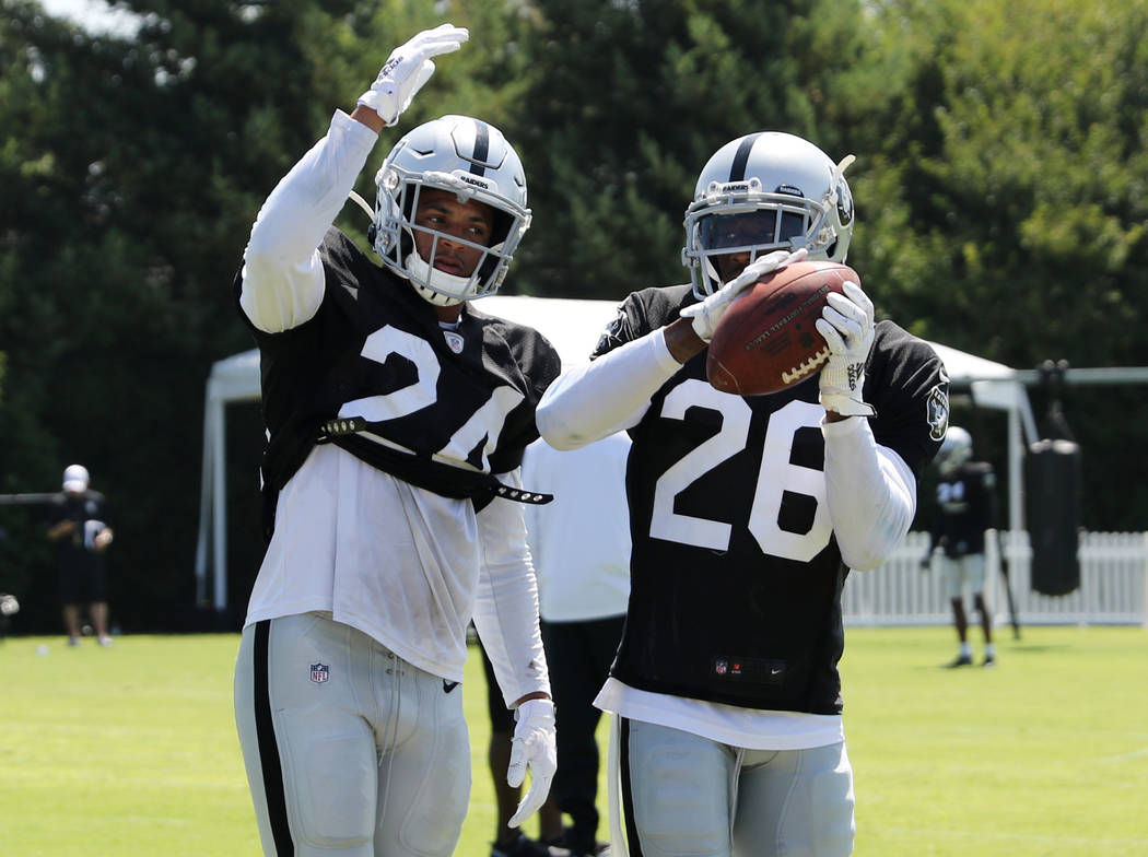 Oakland Raiders safety Johnathan Abram (24) tries to tip the football as cornerback Nevin Lawso ...