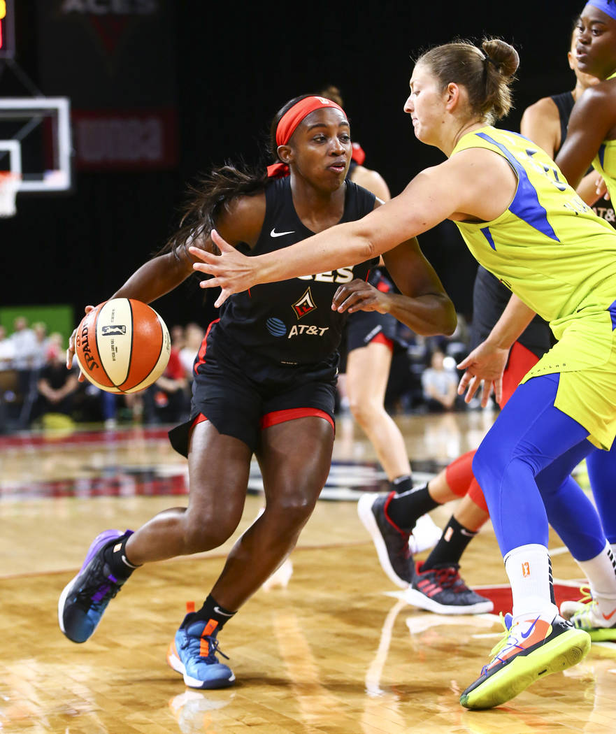 Las Vegas Aces' Jackie Young drives to the basket against Dallas Wings' Theresa Plaisance durin ...