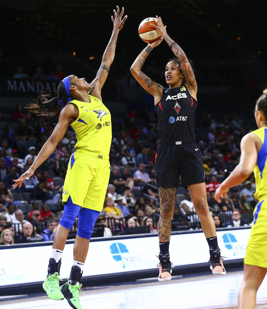 Las Vegas Aces' Tamera Young shoots over Dallas Wings' Glory Johnson during the second half of ...