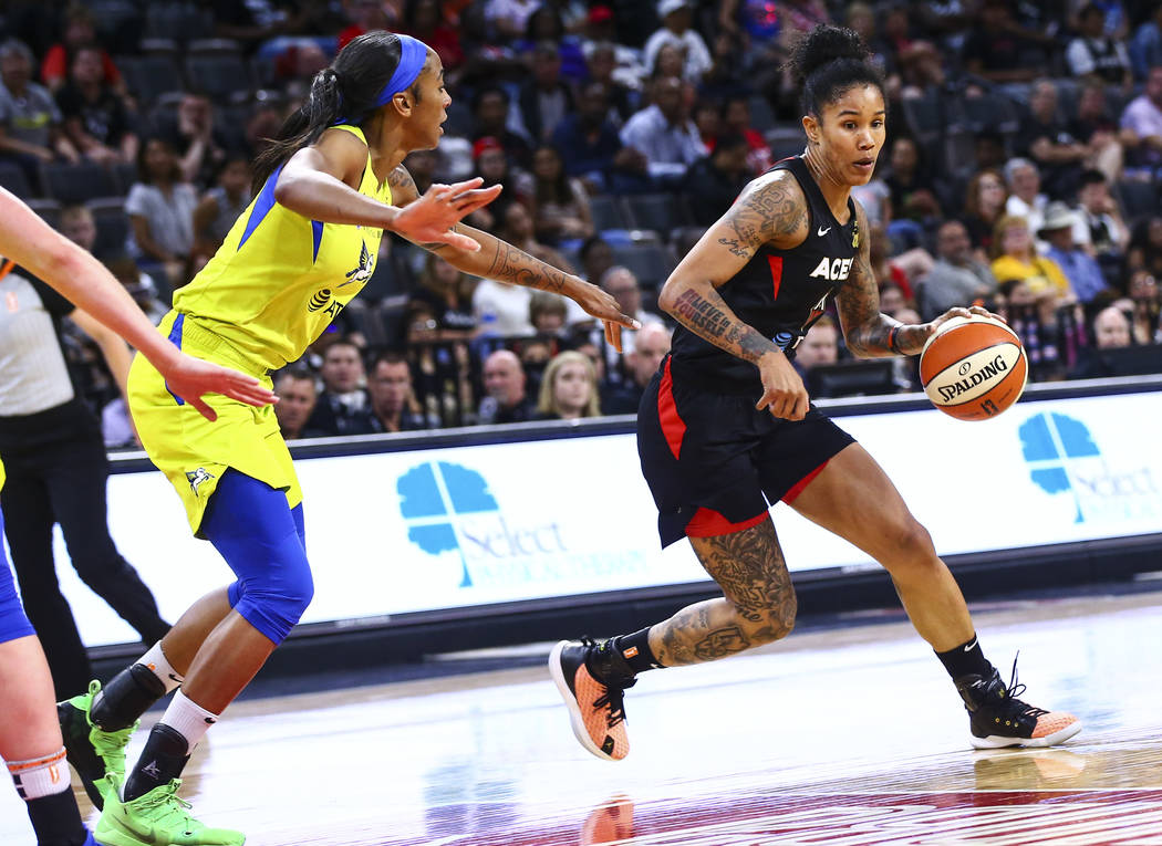 Las Vegas Aces' Tamera Young drives to the basket against Dallas Wings' Glory Johnson during th ...