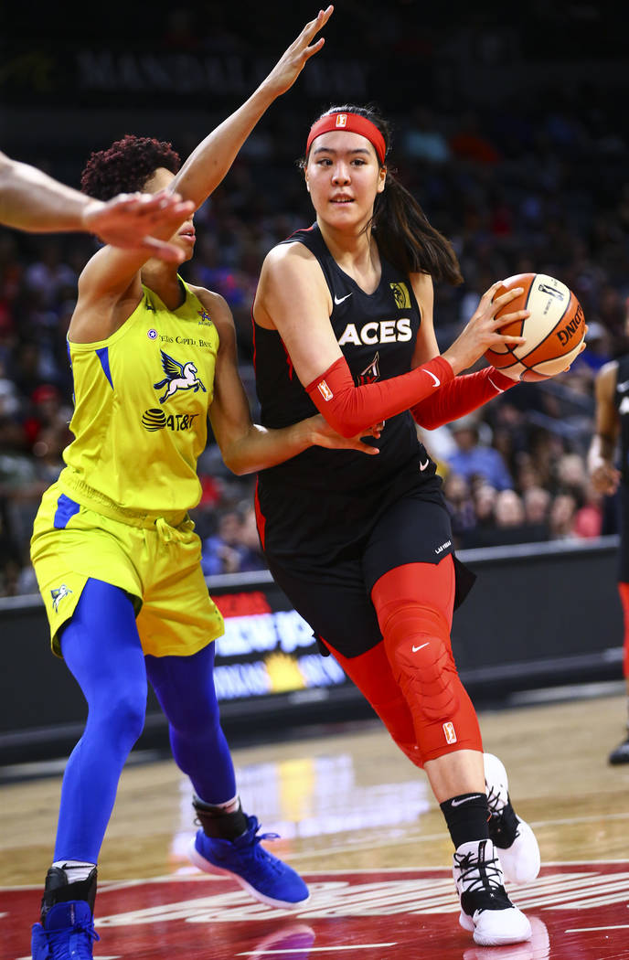 Las Vegas Aces' Ji-Su Park drives to the basket against Dallas Wings' Isabelle Harrison during ...