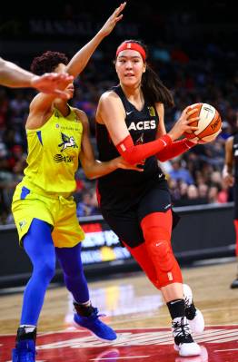 Las Vegas Aces' Ji-Su Park drives to the basket against Dallas Wings' Isabelle Harrison during ...