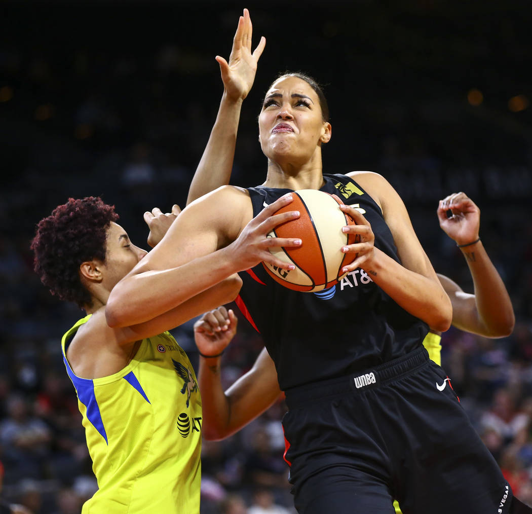 Las Vegas Aces' Liz Cambage drives to the basket against Dallas Wings' Isabelle Harrison during ...
