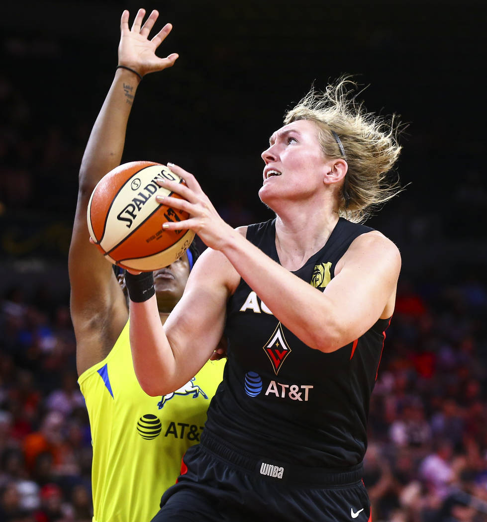 Las Vegas Aces' Carolyn Swords goes to the basket against Dallas Wings' Kaela Davis during the ...