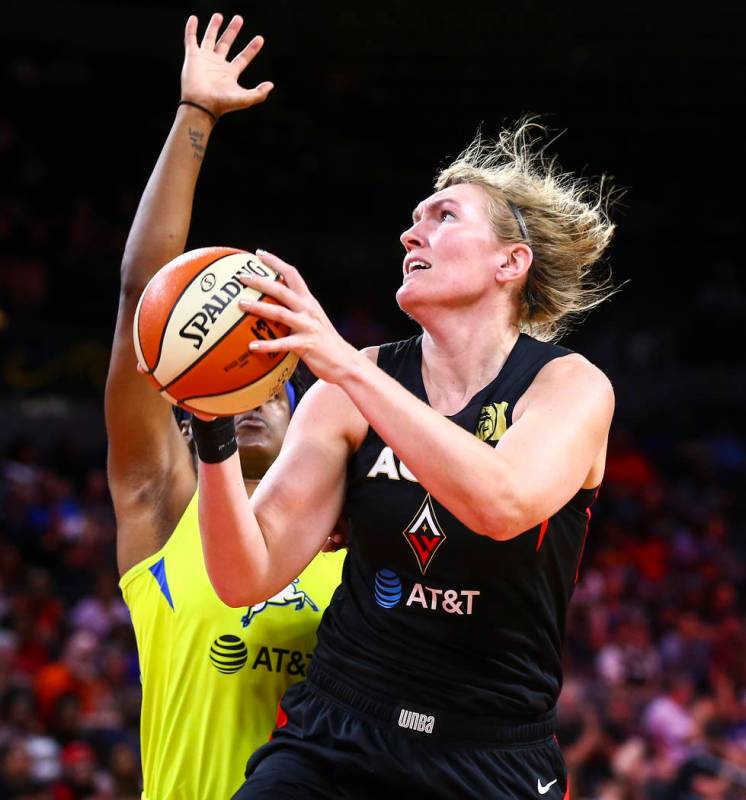 Las Vegas Aces' Carolyn Swords goes to the basket against Dallas Wings' Kaela Davis during the ...