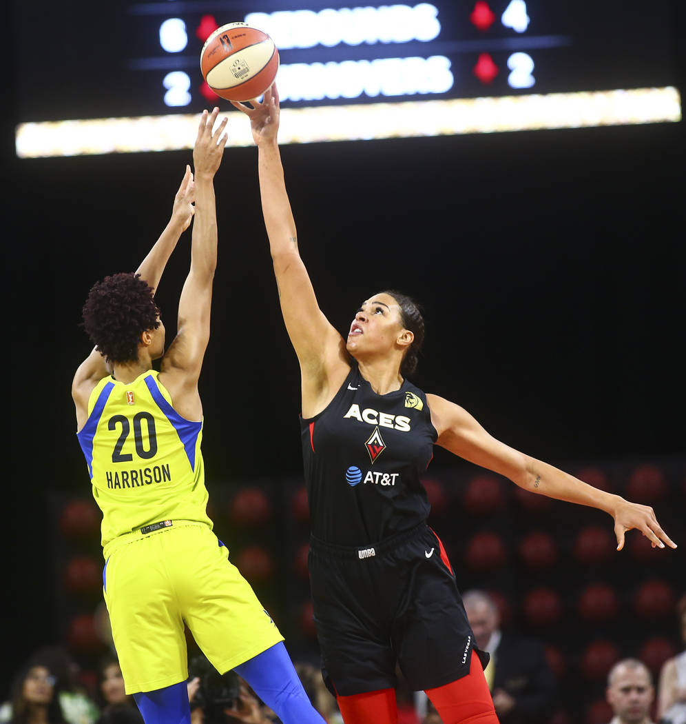 Las Vegas Aces' Liz Cambage blocks a shot from Dallas Wings' Isabelle Harrison (20) during the ...