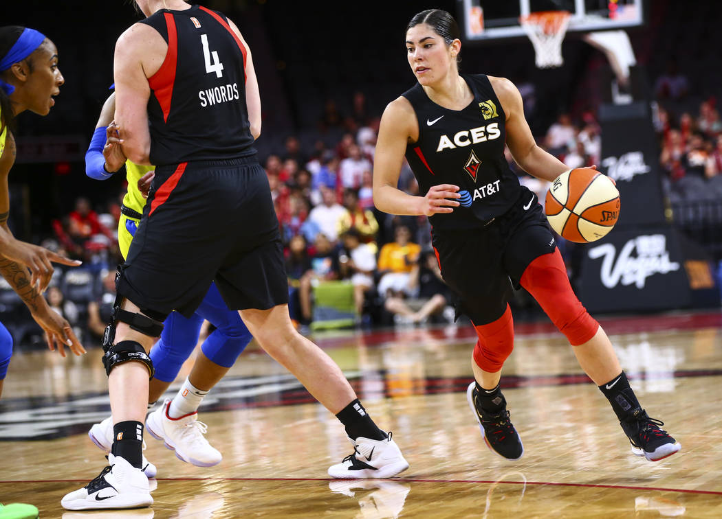 Las Vegas Aces' Kelsey Plum brings the ball up court againt the Dallas Wings during the second ...