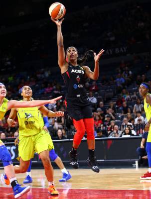 Las Vegas Aces' Sydney Colson shoots against the Dallas Wings during the first half of a WNBA b ...