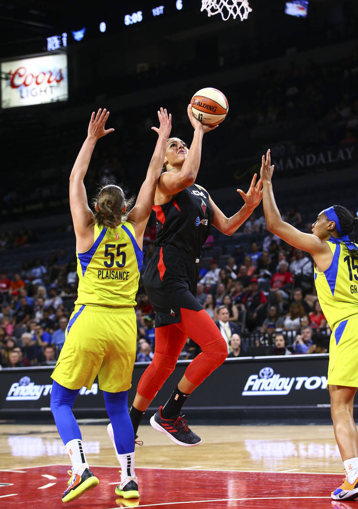 Las Vegas Aces' Liz Cambage goes to the basket between Dallas Wings' Theresa Plaisance (55) and ...