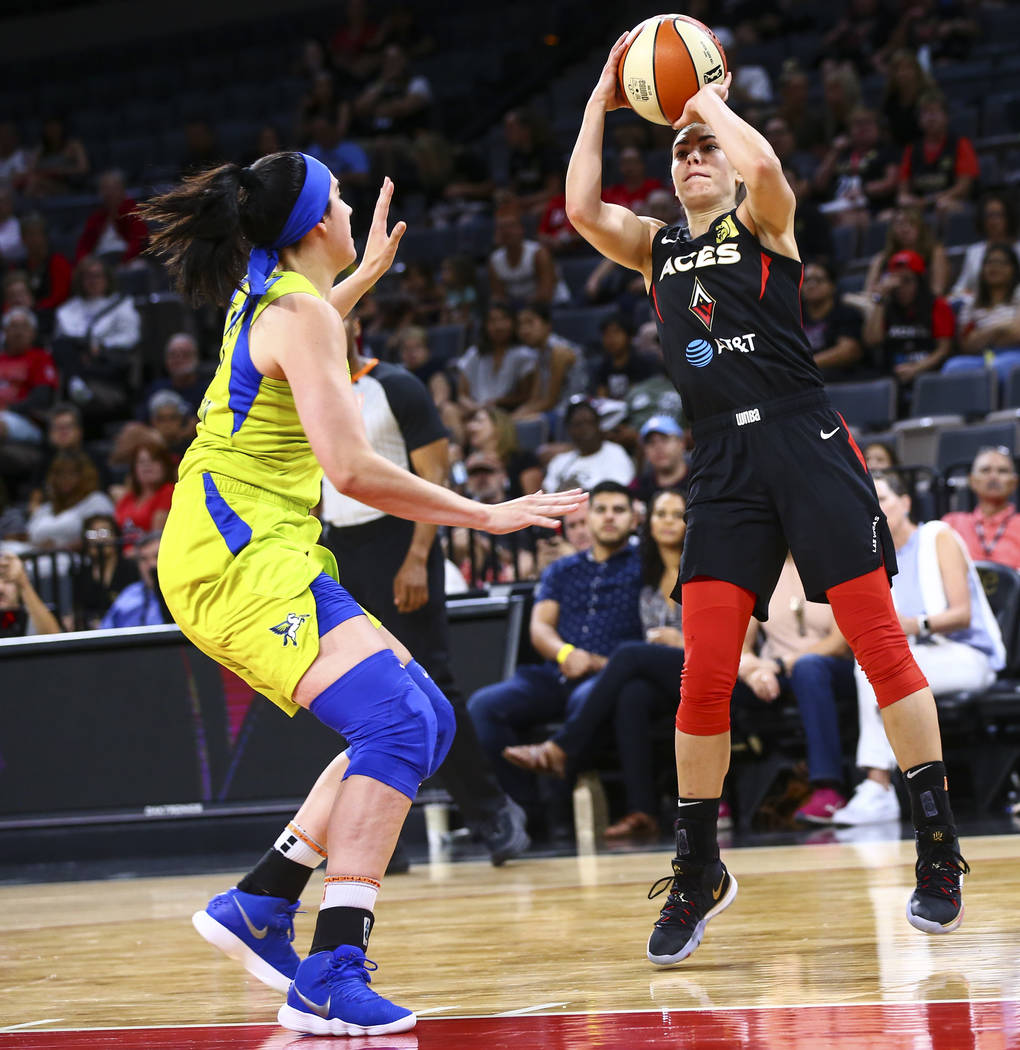 Las Vegas Aces' Kelsey Plum shoots over Dallas Wings' Megan Gustafson during the first half of ...