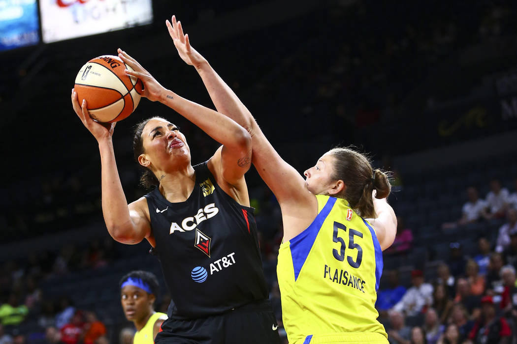 Las Vegas Aces' Liz Cambage shoots around Dallas Wings' Theresa Plaisance (55) during the first ...
