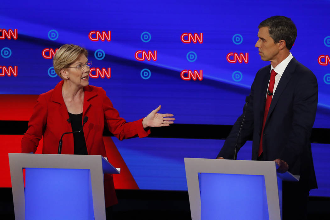 Sen. Elizabeth Warren, D-Mass., gestures to former Texas Rep. Beto O'Rourke during the first of ...