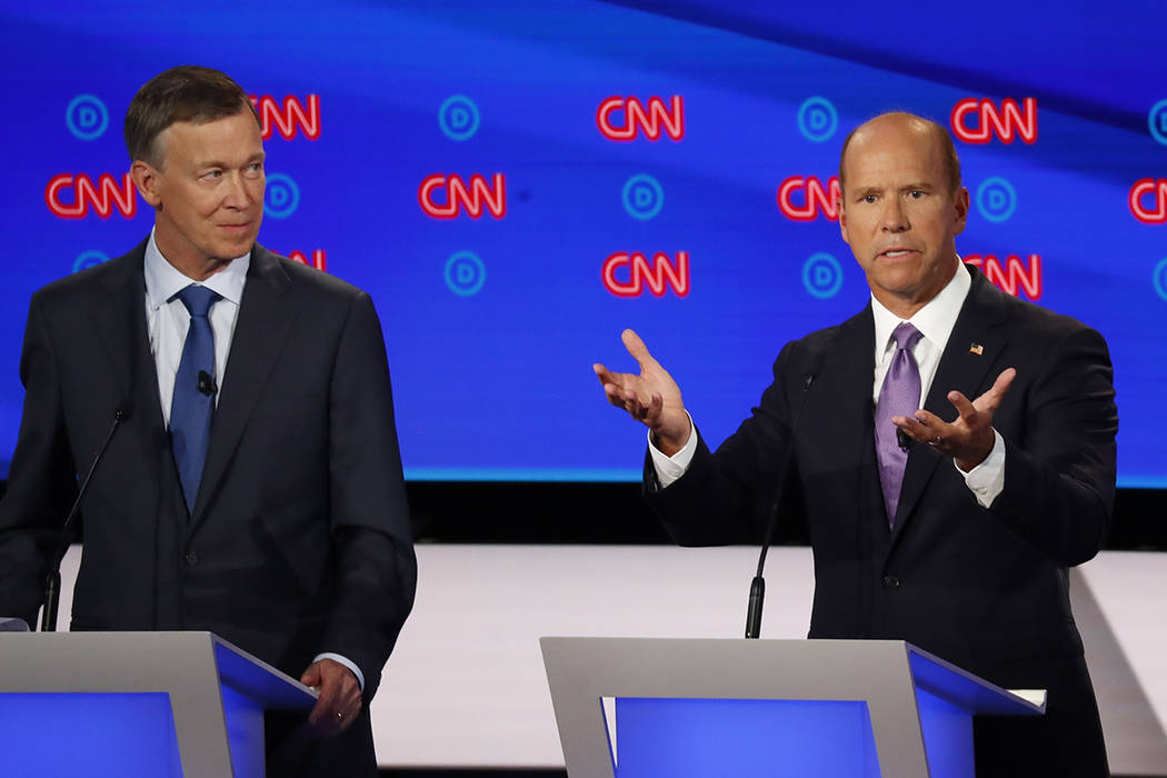 Former Colorado Gov. John Hickenlooper watches as former Maryland Rep. John Delaney speaks duri ...