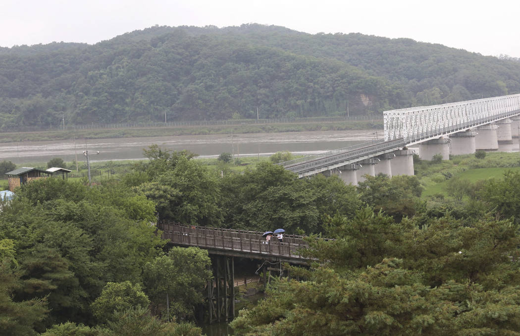 Visitors walk on the Freedom Bridge at the Imjingak Pavilion in Paju, near the border with Nort ...