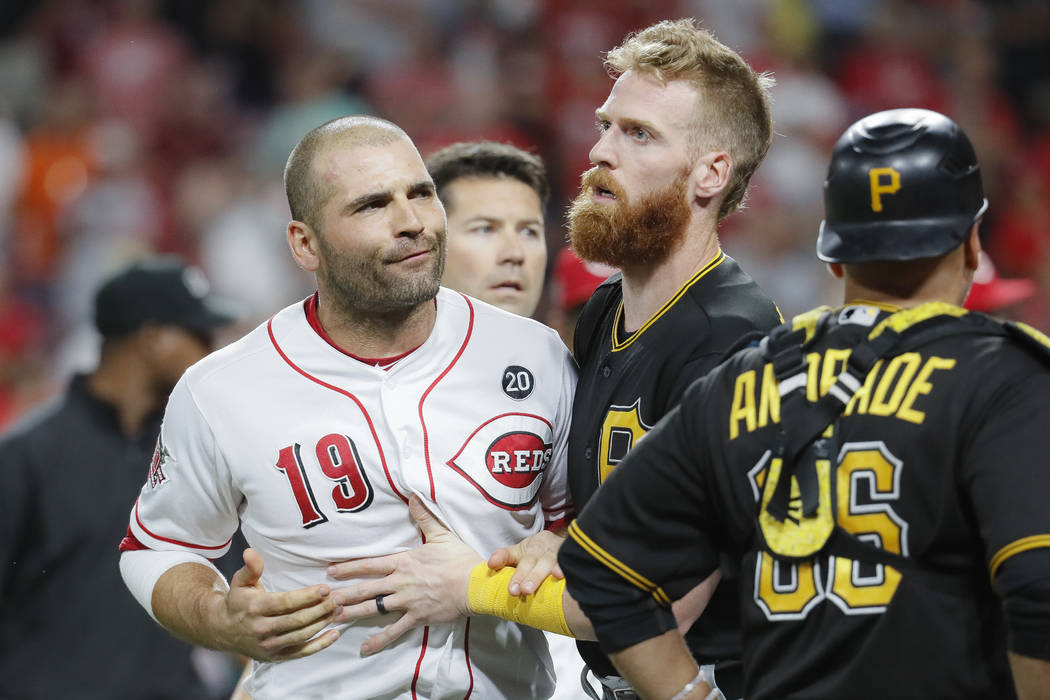 Cincinnati Reds first baseman Joey Votto (19) is restrained by Pittsburgh Pirates third baseman ...