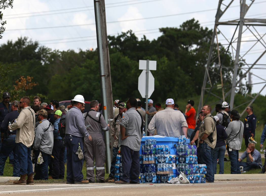 Evacuated Exxon Mobile workers take a break or watch the fire from the Baytown Olefins Plant en ...