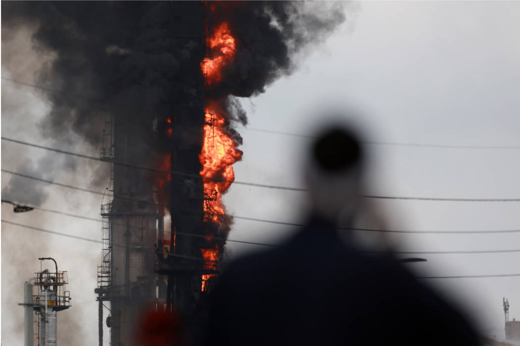 Flames and smoke rise after a fire started at an Exxon Mobil facility, Wednesday, July 31, 2019 ...