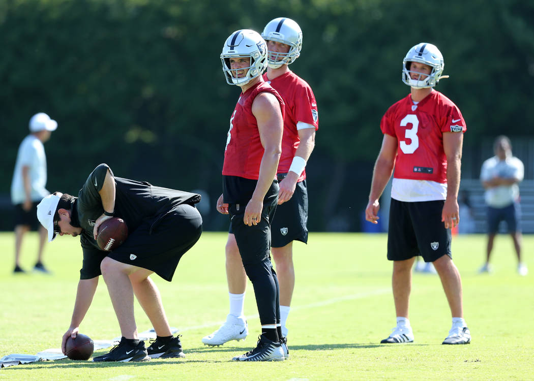 Oakland Raiders quarterbacks, from left, Derek Carr (4), Mike Glennon (7) and Nathan Peterman ( ...