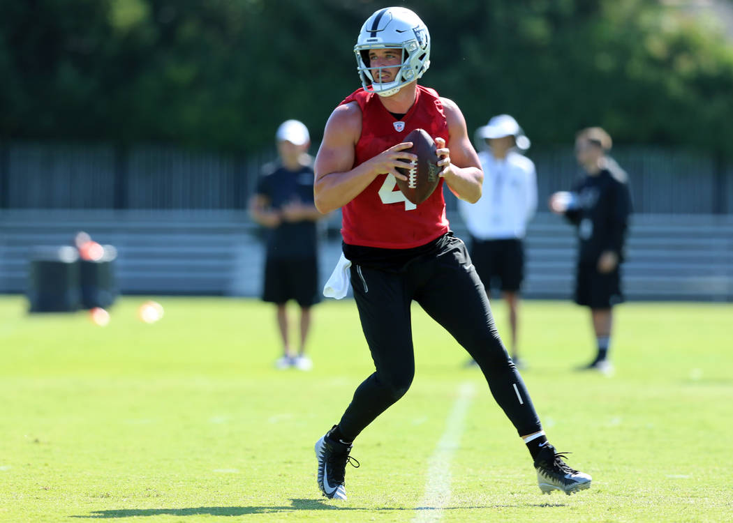 Oakland Raiders quarterback Derek Carr (4) drops back to pass during the NFL team's training ca ...