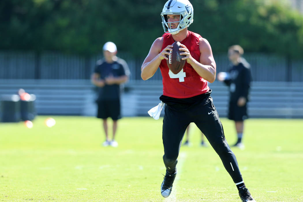 Oakland Raiders quarterback Derek Carr (4) drops back to pass during the NFL team's training ca ...