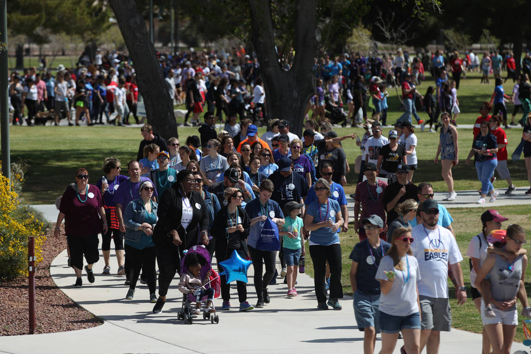 People participate during the Out of the Darkness Suicide Prevention Walk at Craig Ranch Park i ...