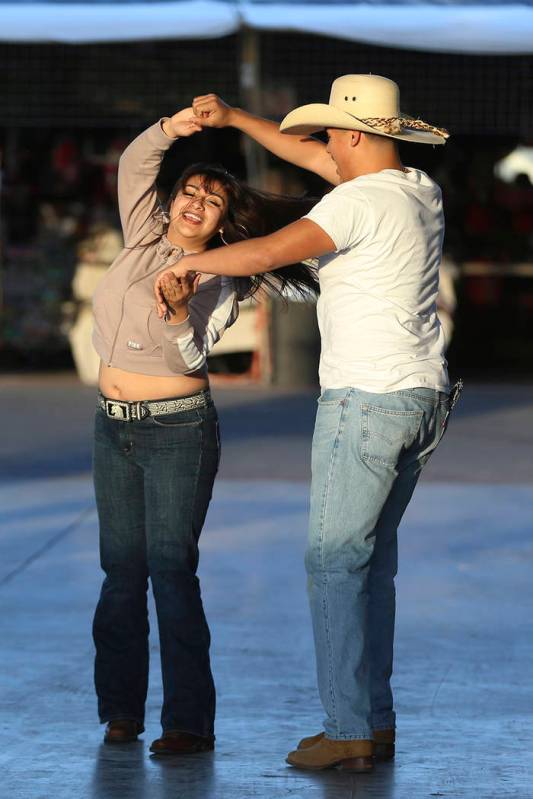 Jackie Canizales, 19, left, and her brother Jessie, 16, of Las Vegas, dance to live music at th ...