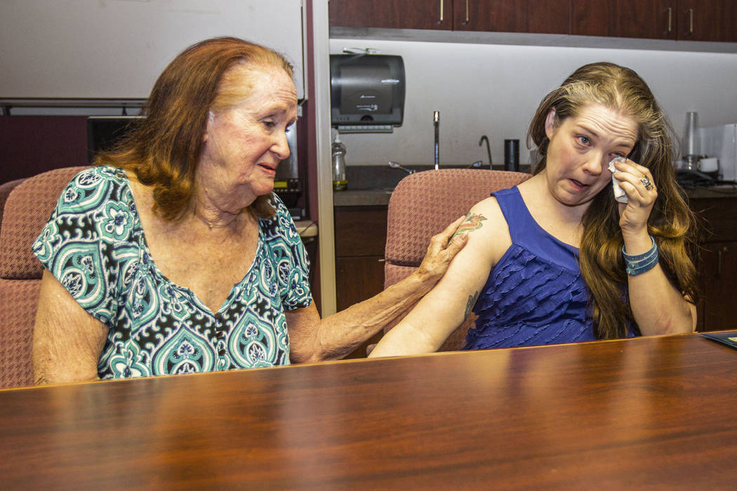 Joan Miller, left, the longest-tenured volunteer with the Trauma Intervention Program, consoles ...