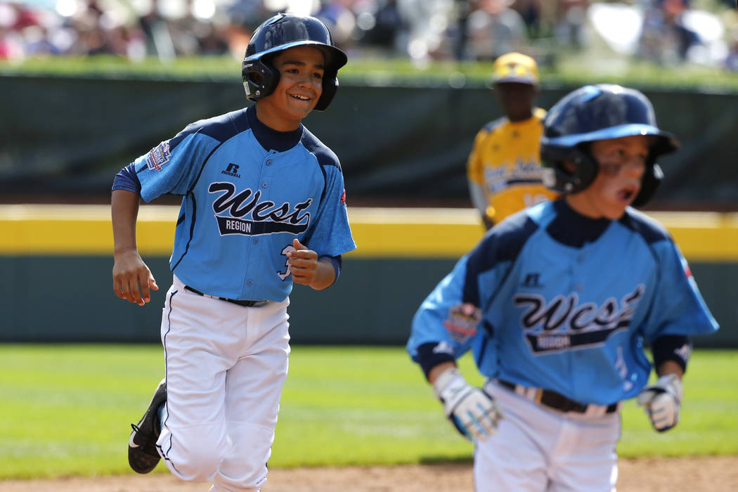 Las Vegas' Dominic Clayton, left, follows teammate Drew Laspaluto around the bases after hittin ...