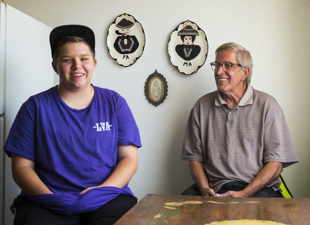 Fifteen-year-old Ryan Lauer, left, with his father, Jack Lauer, at their home near downtown Las ...