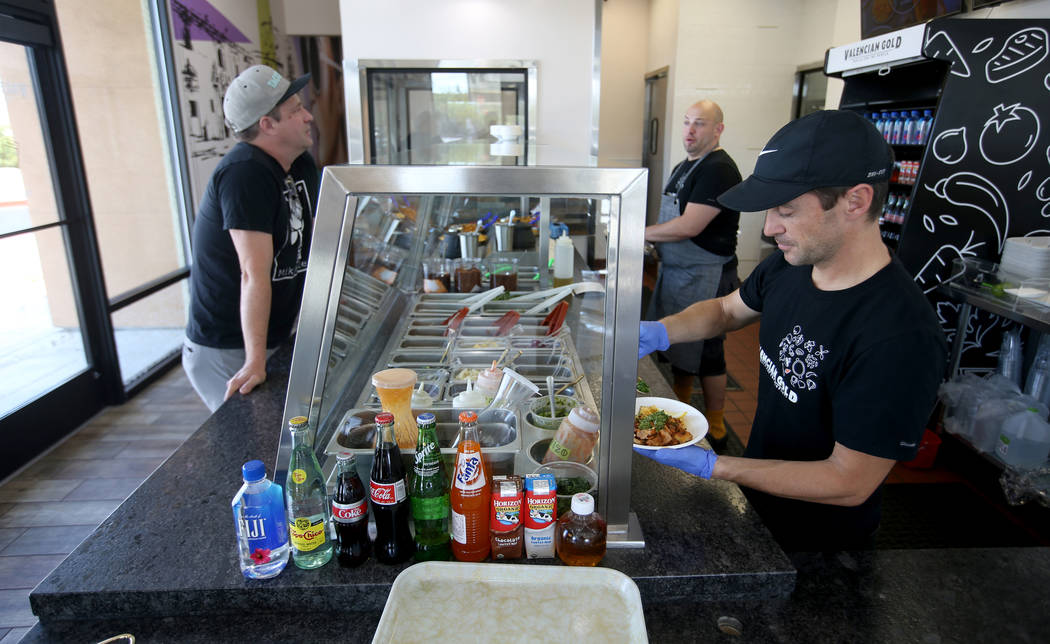 Kevin LaFleur, right, makes a custom bowl for John Simmons at Valencian Gold in Las Vegas Thurs ...