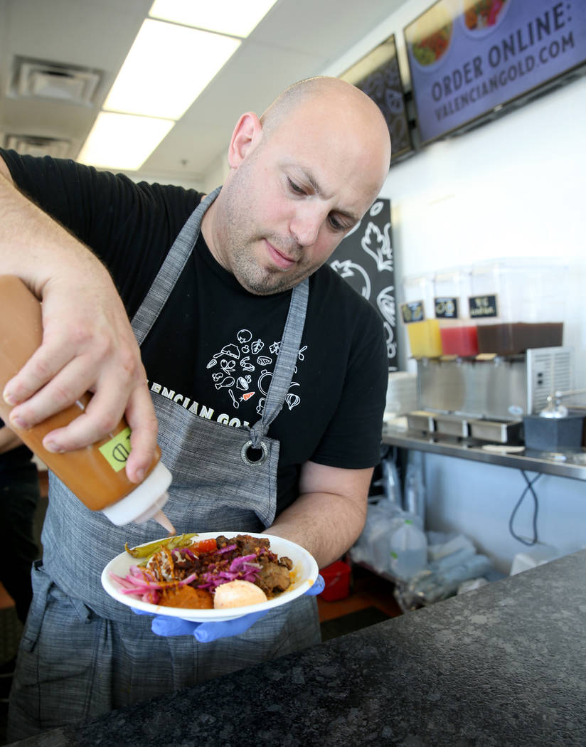 Chef and co-owner Jeffrey Weiss sauces a custom bowl at Valencian Gold in Las Vegas Thursday, J ...