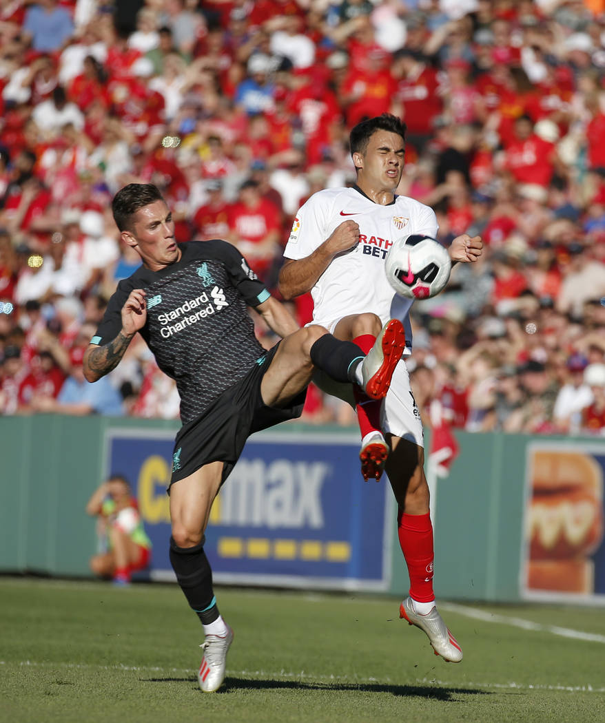 Liverpool's Harry Wilson, left, and Sevilla's Reguilon Rodriguez Sergio vie for the ball during ...