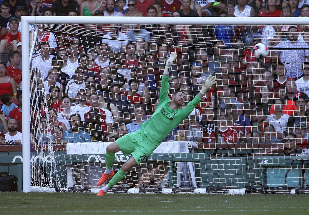 Liverpool goalie Andy Longergan is unable to make the save on a goal by Sevilla's Aguido Duran ...