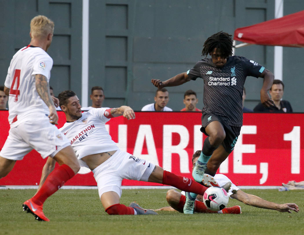 Liverpool's Yasser Larouci powers through a slide from Sevilla's Escudero during the second hal ...
