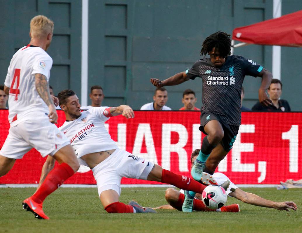 Liverpool's Yasser Larouci powers through a slide from Sevilla's Escudero during the second hal ...