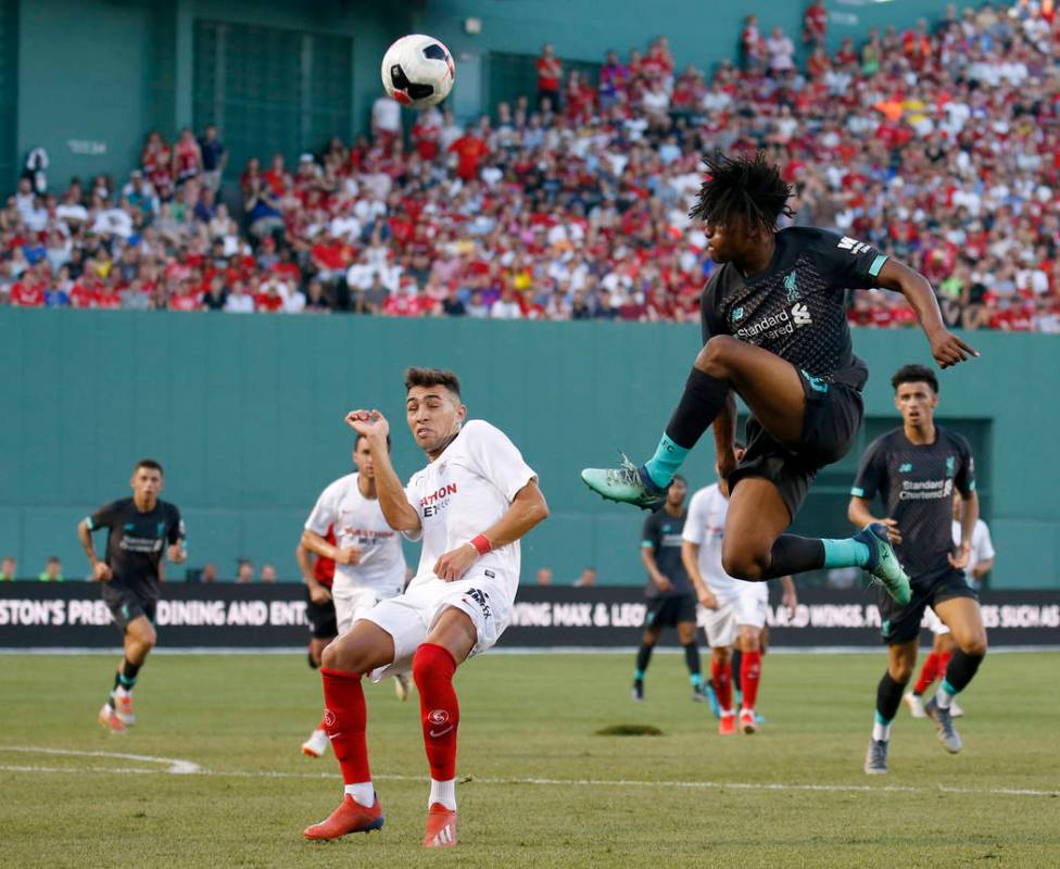 Liverpool's Yasser Larouci, front right, jumps for a ball against Sevilla's Munir during the se ...