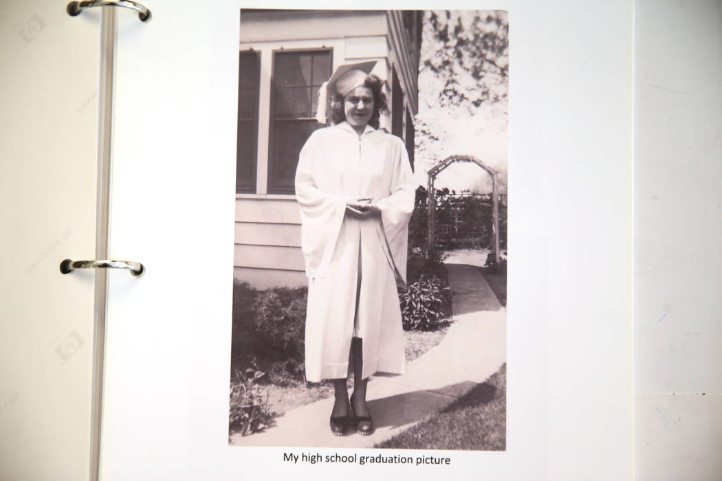 Etta Baykara, 91, shows a picture of herself in her high school graduation gown at her home in ...