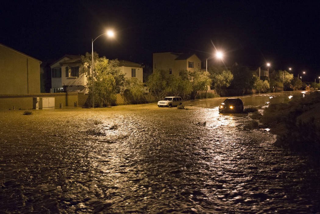 Two vehicles are stuck in nearly three feet of floodwaters near the intersection of West Fitzwi ...