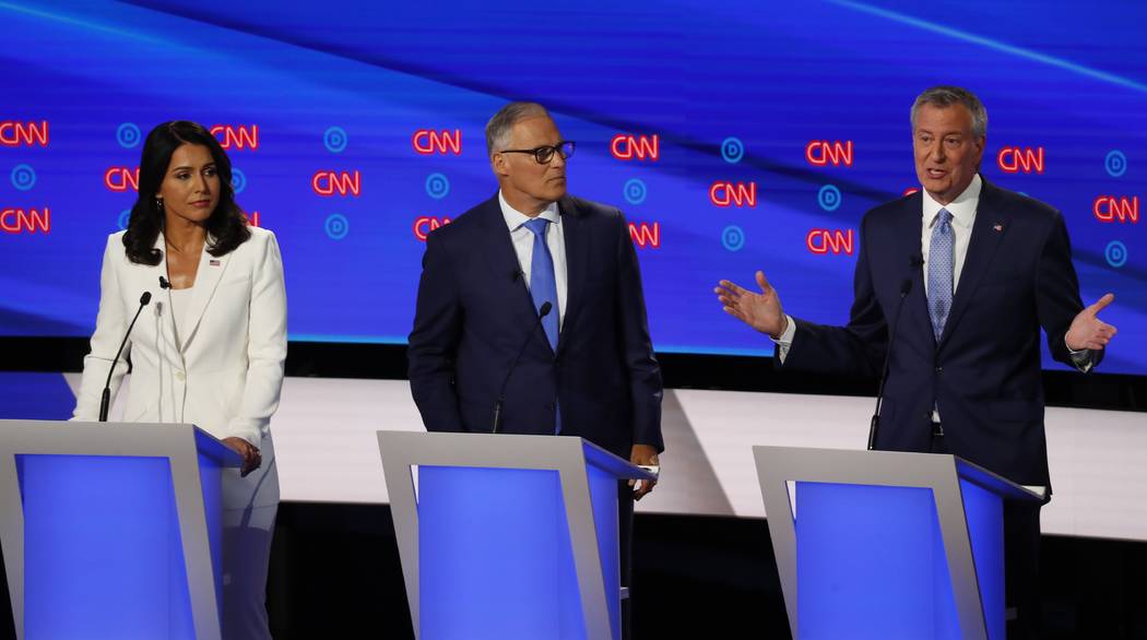 From left, Rep. Tulsi Gabbard, D-Hawaii, Washington Gov. Jay Inslee and New York City Mayor Bil ...