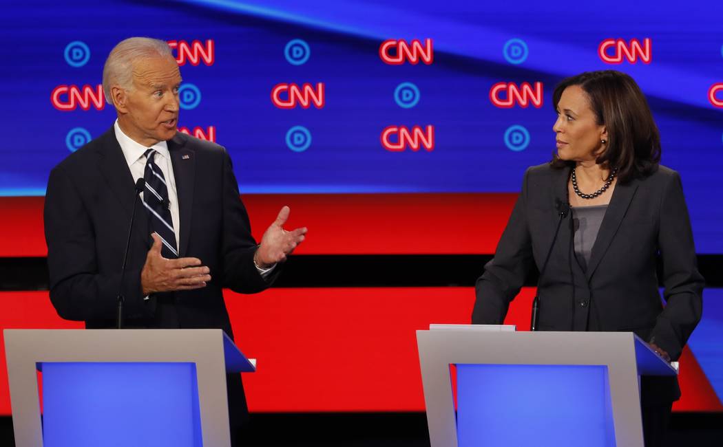 Sen. Kamala Harris, D-Calif., listens as former Vice President Joe Biden speaks during the seco ...