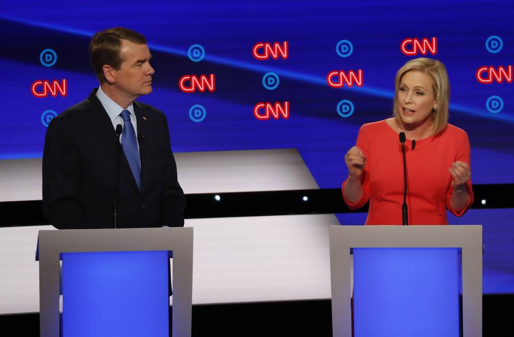 Sen. Michael Bennet, D-Colo., listens as Sen. Kirsten Gillibrand, D-N.Y. speaks during the seco ...