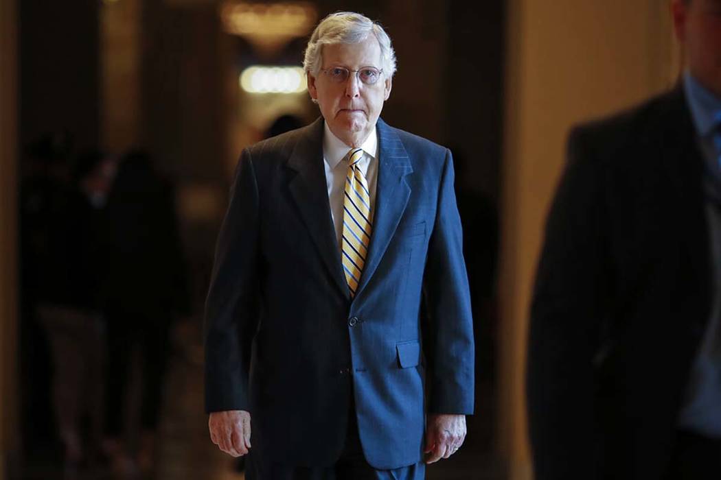 Senate Majority Leader Mitch McConnell, R-Ky., walks to the Senate chamber for votes on federal ...