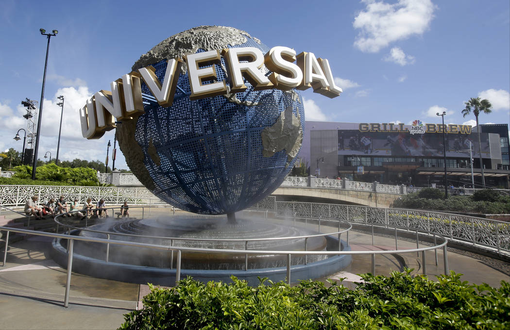 In this Oct. 22, 2015,file photo, park guests relax and cool off with a water mist under the gl ...