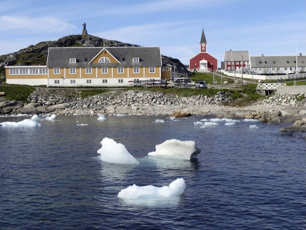 In this image taken on June 13, 2019 small pieces of ice float in the water off the shore in Nu ...