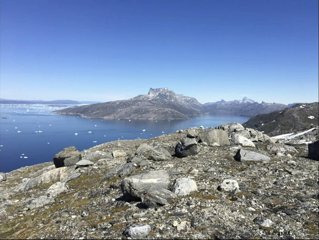 In this image taken on June 15, 2019 small pieces of ice float in the water in Nuuk Fjord, Gree ...