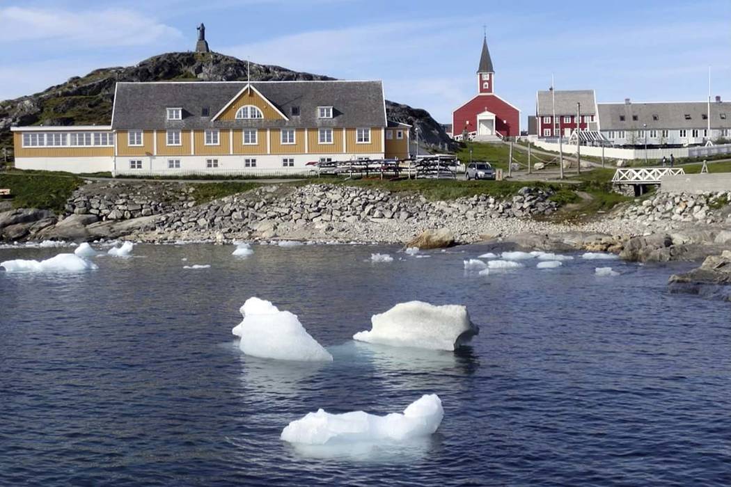 In this image taken on June 13, 2019 small pieces of ice float in the water off the shore in Nu ...