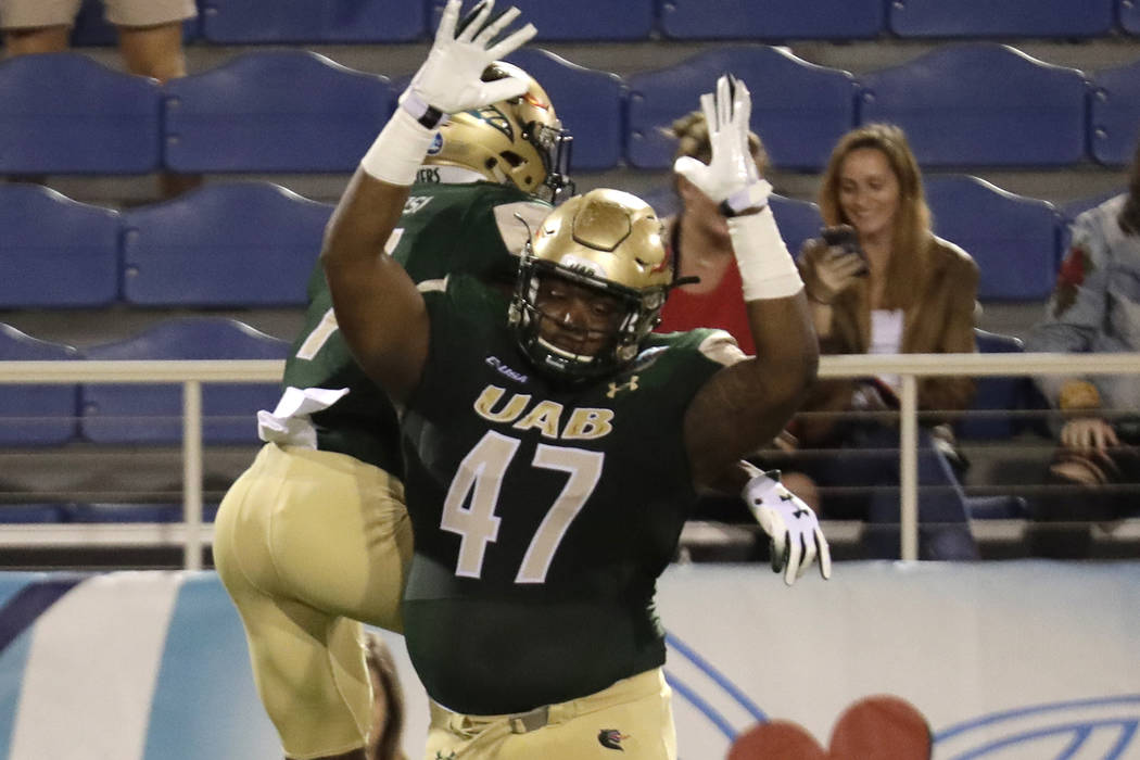 UAB defensive lineman Anthony Rush (47) celebrates with wide receiver Xavier Ubosi after Ubosi ...