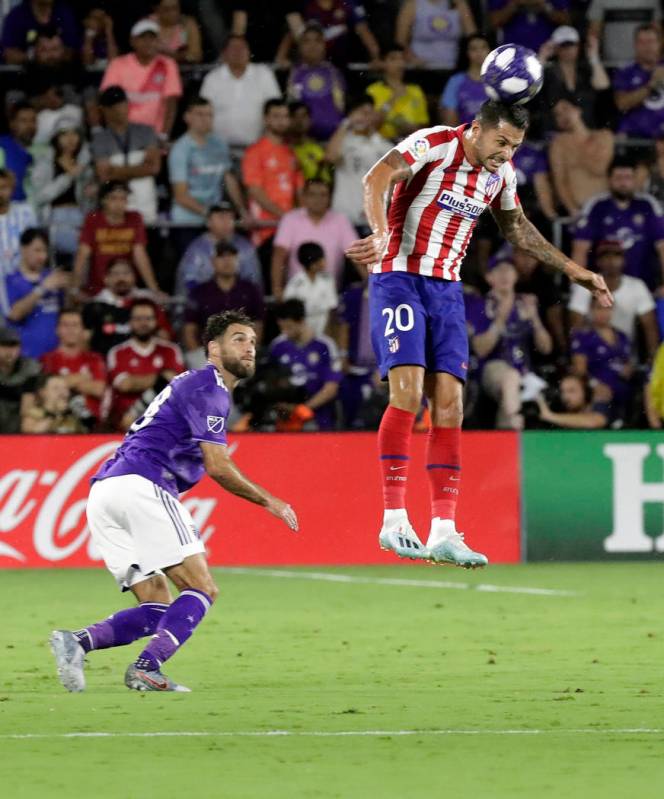 Atletico Madrid midfielder Vitolo (20) clears the ball away from Sporting Kansas City defender ...