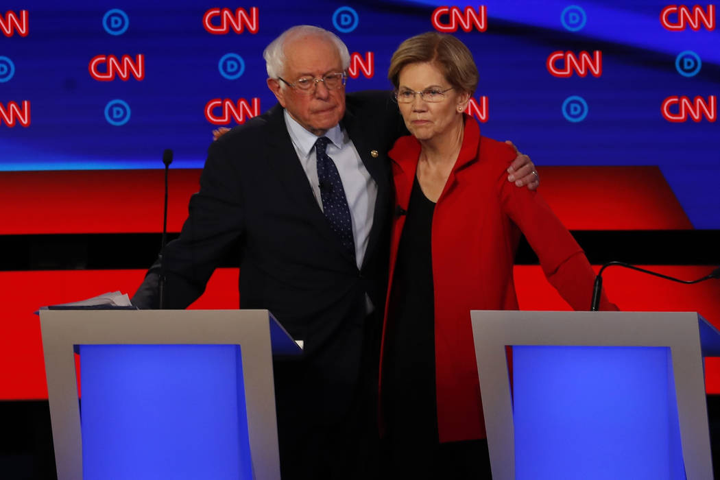 Sen. Bernie Sanders, I-Vt., and Sen. Elizabeth Warren, D-Mass., embrace after the first of two ...