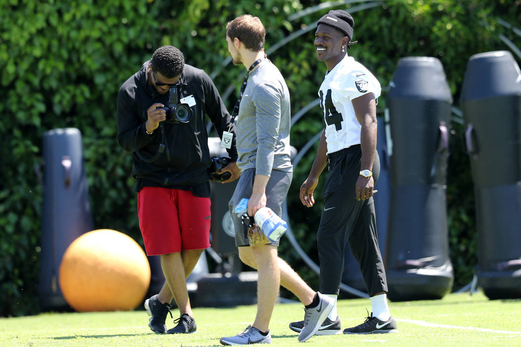 Oakland Raiders wide receiver Antonio Brown (84), right, walks on the field during the NFL team ...